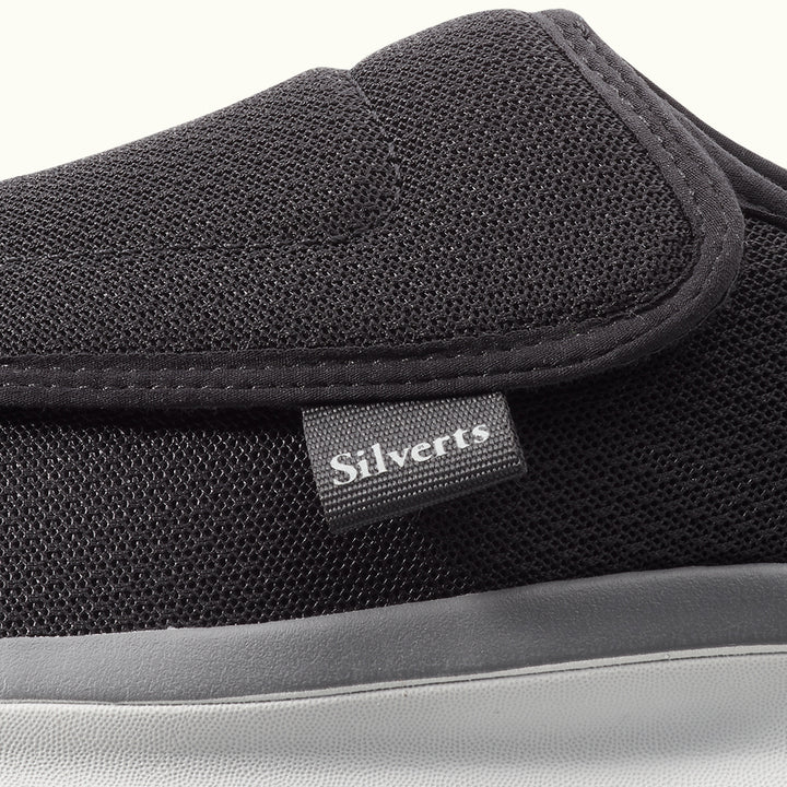 Up close view of Black Men's Extra Wide Comfort Shoes with gray soles on a white background