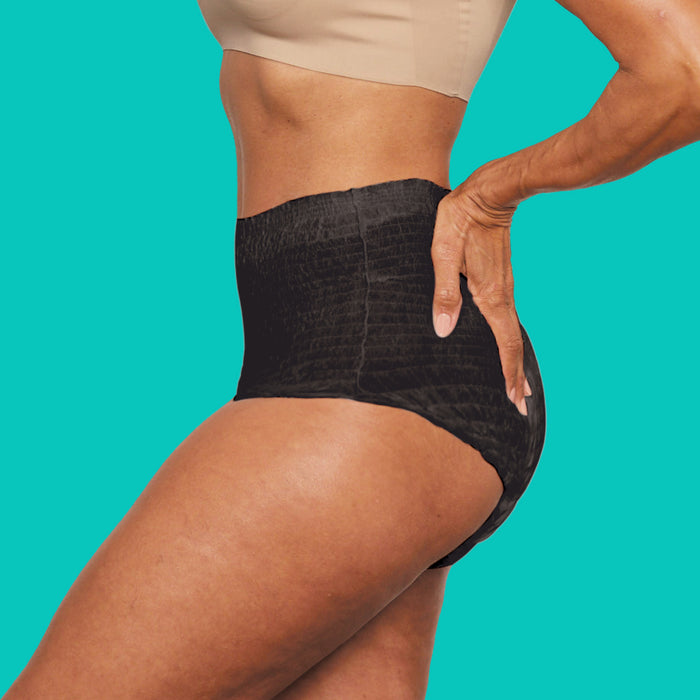 A woman wearing sleek black incontinence underwear.
