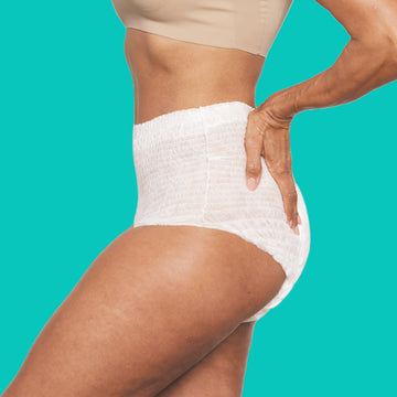 A woman wearing sleek white incontinence underwear.