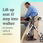 Man using White Aluminum Premium Folding Rollator Walker to access a sink in a bathroom with text "lift up seat and step into walker to access sinks and counters" on light yellow background