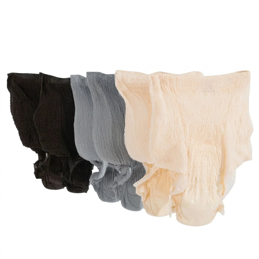 Protective underwear from the variety pack lined up in all three colors, black, grey and beige, on a white background.