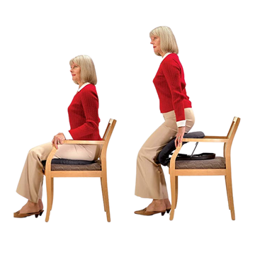 Woman wearing a red sweater and khaki pants displaying how to use the cushion set and how to get it from cushion on seat. 