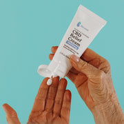 CBD Relief Cream being dispensed into a woman's hands