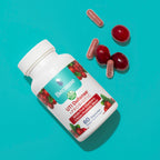 Because UTI defense and probiotic supplement bottle with cranberries on the label and red supplements spilling on to a blue surface next to cranberries.