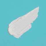 A white smear of skin cream on a blue background