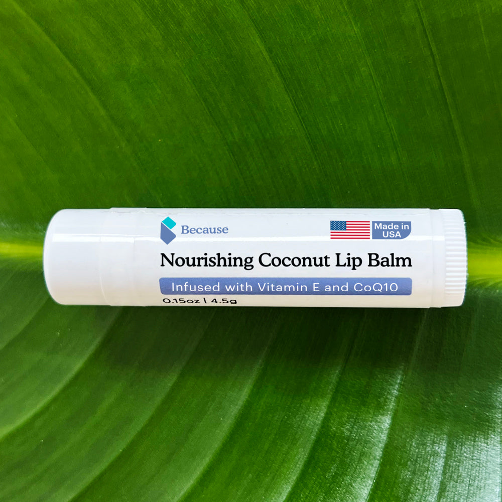 Nourishing coconut lip balm on a green leaf