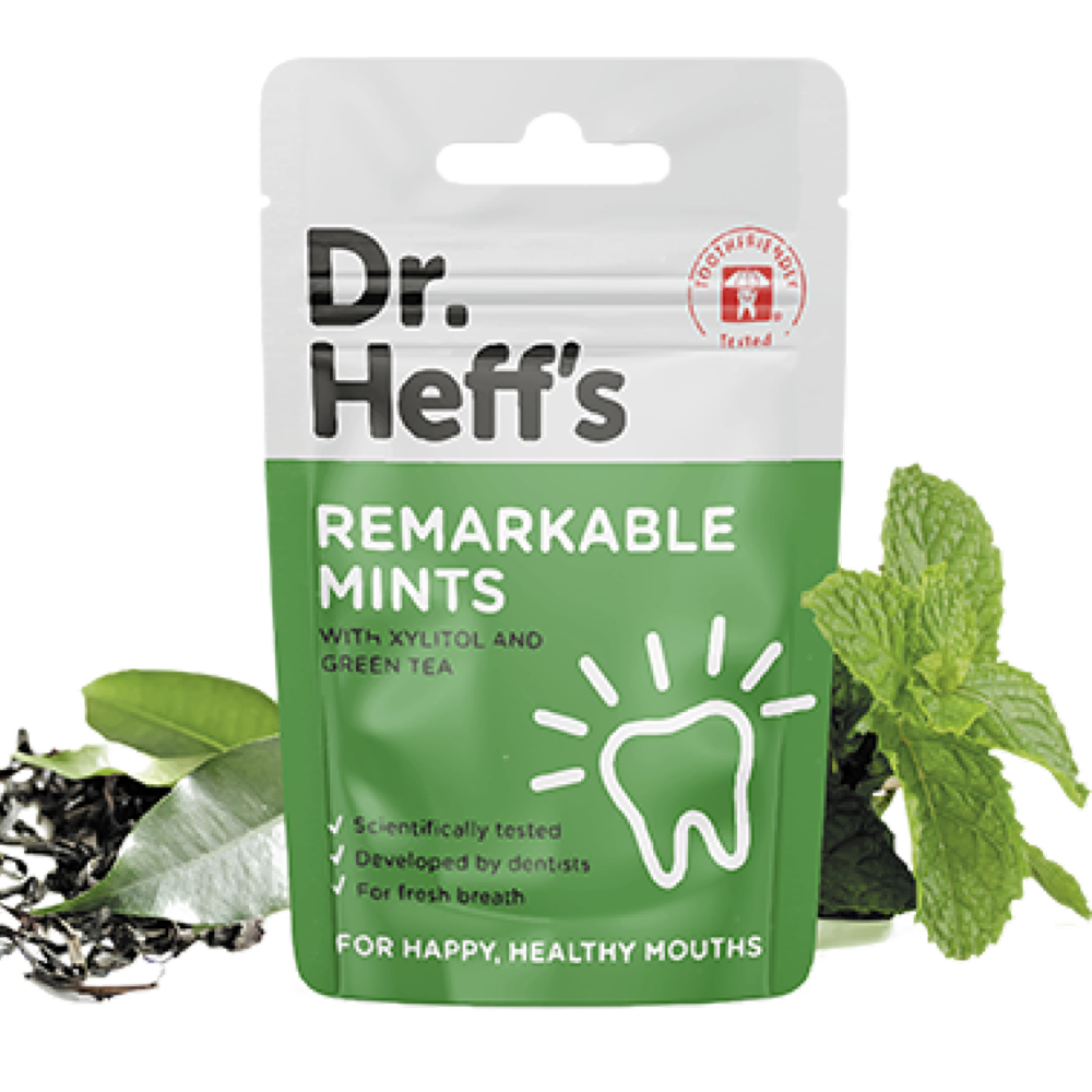 Package of Dr Heffs mints alongside a sprig of green mint