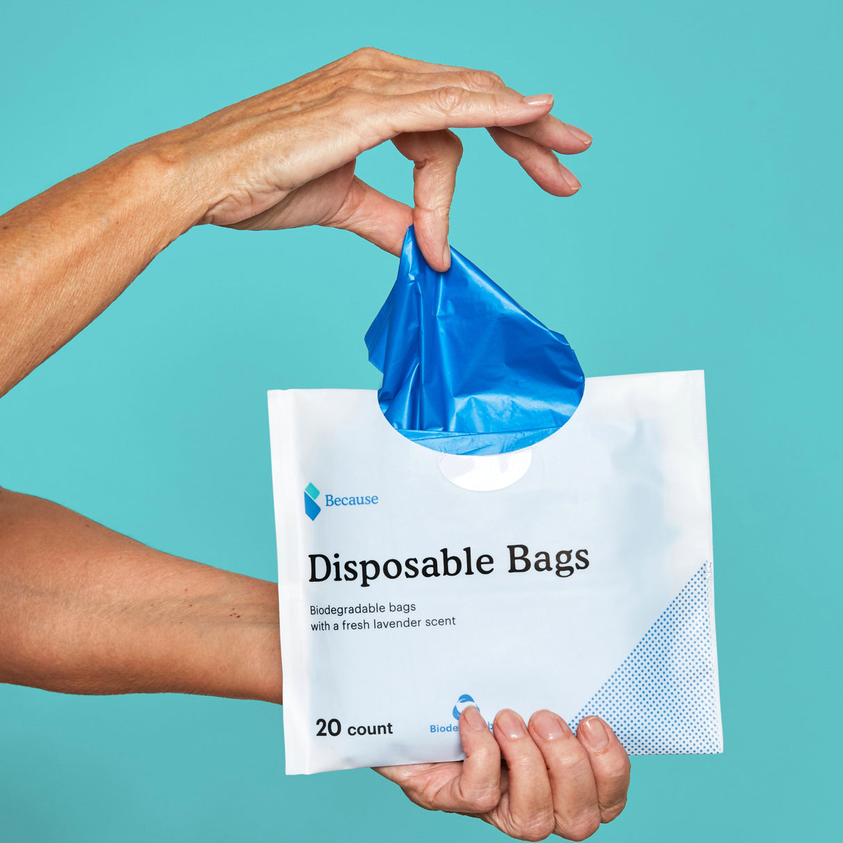 A woman dispensing the biodegradable bags from the package