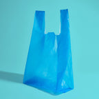 A blue opaque Because disposal bag with long tie handles on teal background