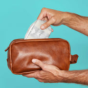 Man putting a guard into a dopp kit