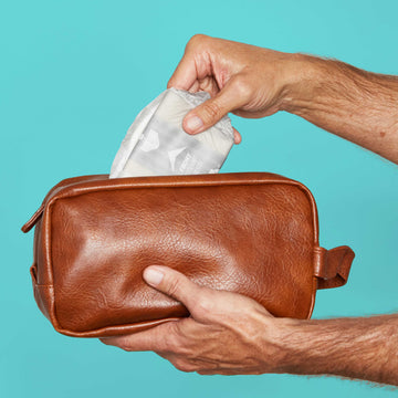 Man putting a guard into a dopp kit