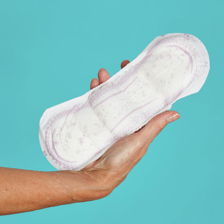 Woman holding a pad in her hand that looks soft