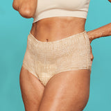 Woman wearing beige form fitting absorbent underwear