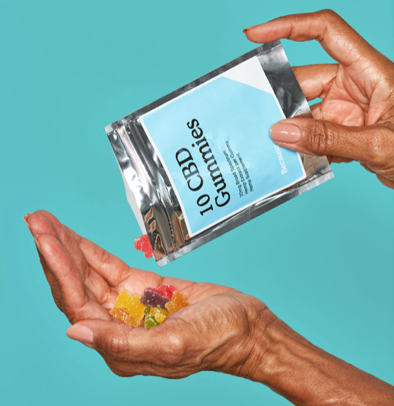 A woman dispensing a 10 pack of CBD gummies into her hands