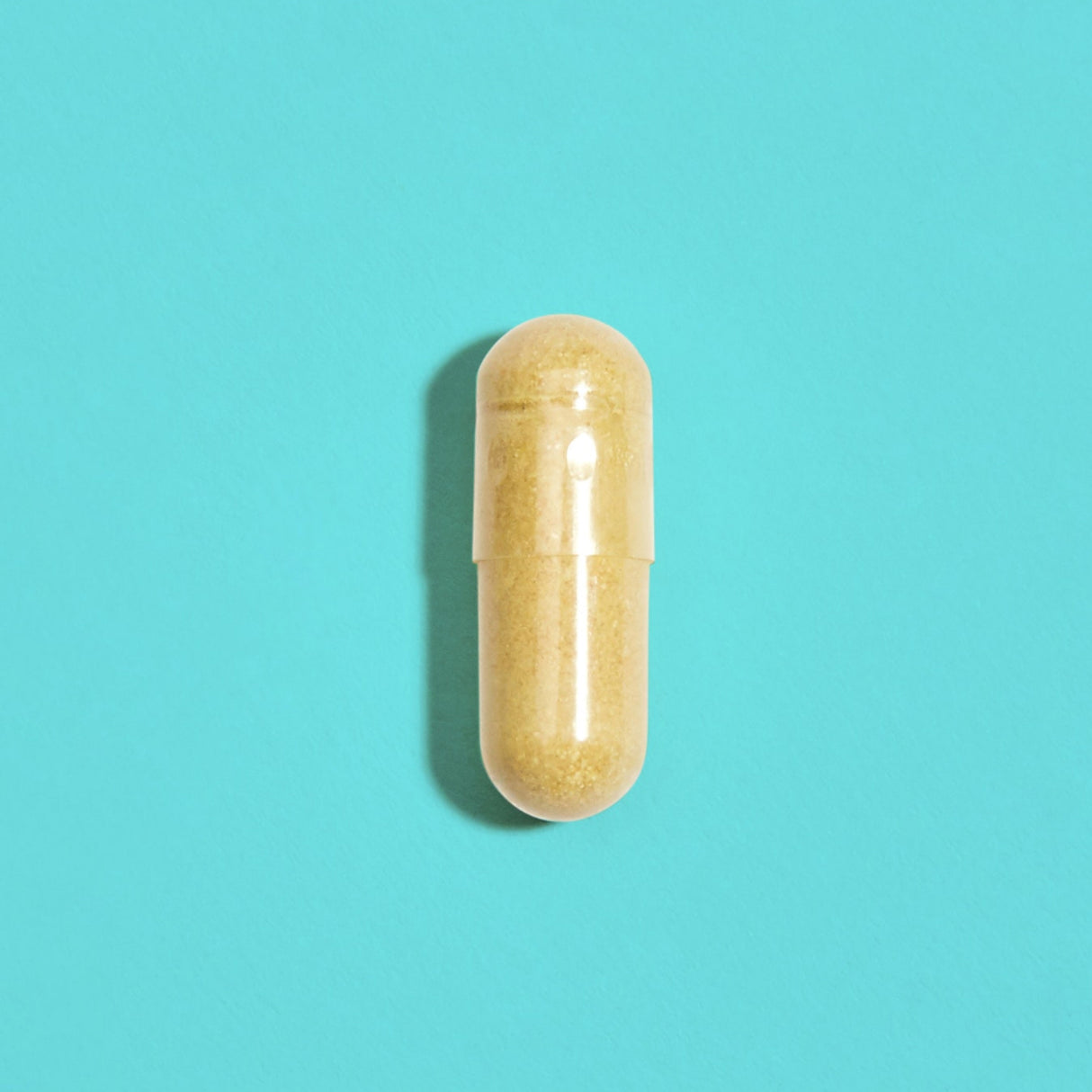 Yellow capsule filled with crushed yellow powder