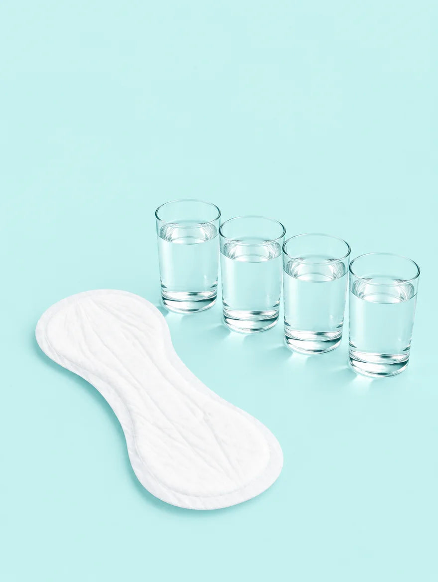 A booster pad next to four glasses of water
