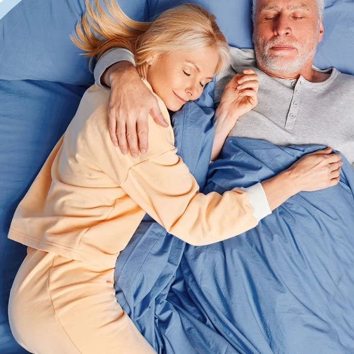 An older couple sleeping peacefully