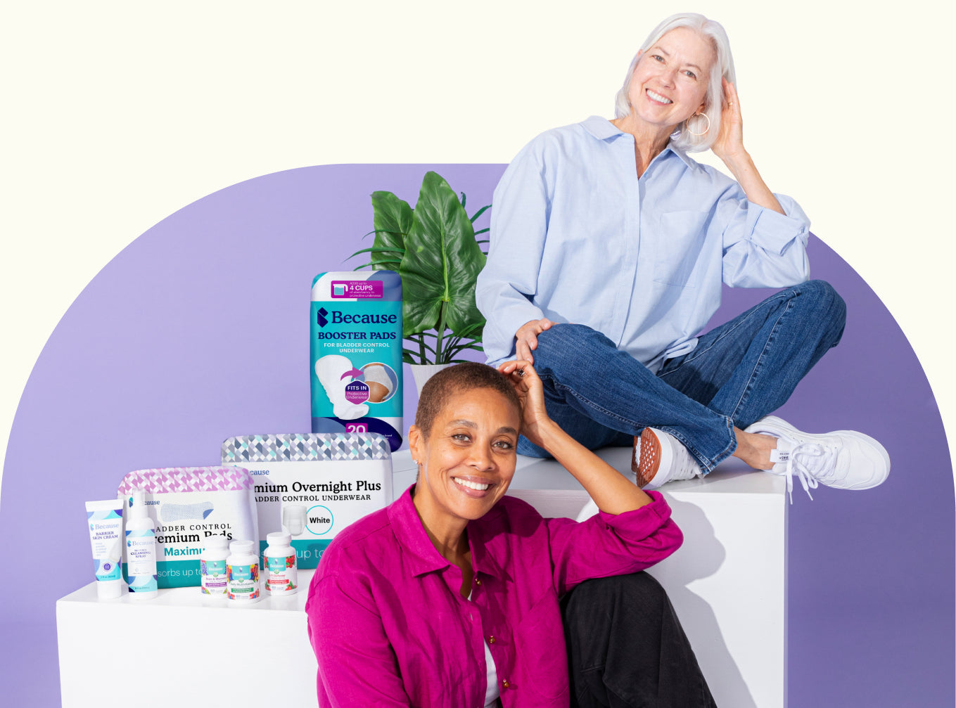 Two women with the full Because product range — booster pads, overnight underwear, premium pads, skin cream, cleansing spray and supplements